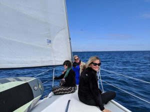 Sara Newton and friends on a sailboat.