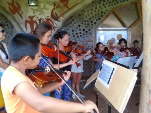 Toki’s Music School students during violin lessons.