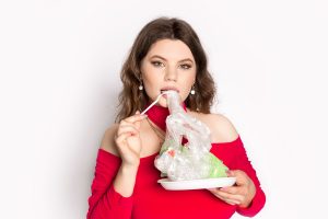 woman eating plastic