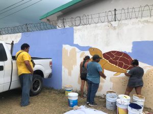 Voluntarios y empleados de Yuumtsil Káak Náab pintan un mural de tortugas en Seybaplaya