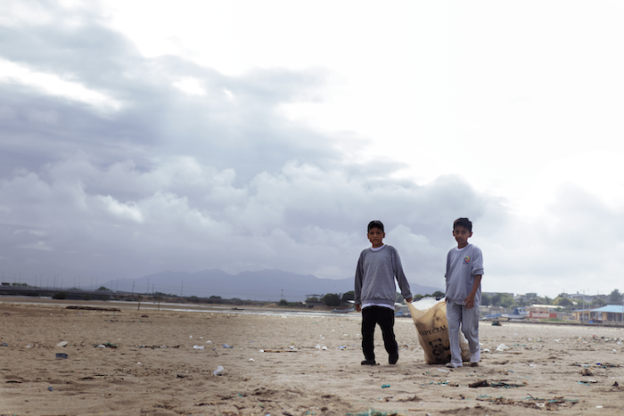 Children clean the beach in Ecuador.