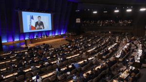 France's President Macron addressing delegates at the UNESCO Headquarters